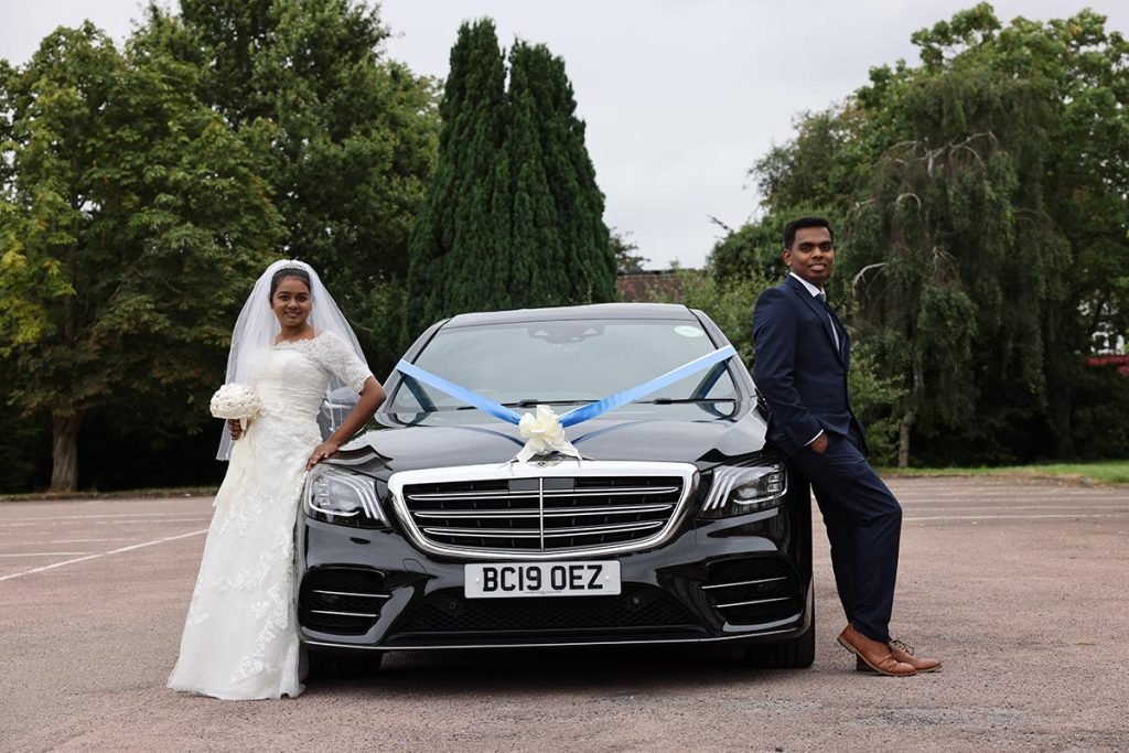 Wedding Photographer in London Bride and groom posing beside their wedding car captured by a Christian Wedding Photographer in London